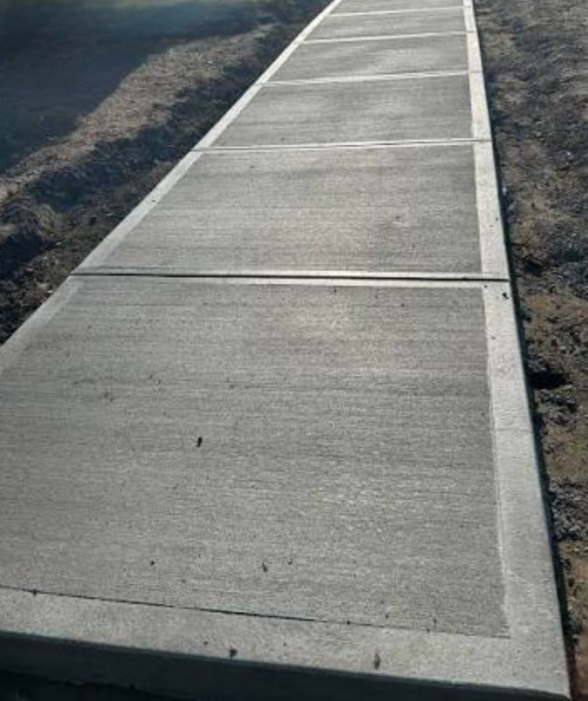 Fresh concrete sidewalk restored